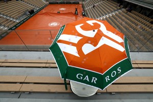 Tennis - French Open - Roland Garros, Paris, France - May 28, 2024 

General view of a person sitting with an umbrella as rain interrupts the play REUTERS/Lisi Niesner