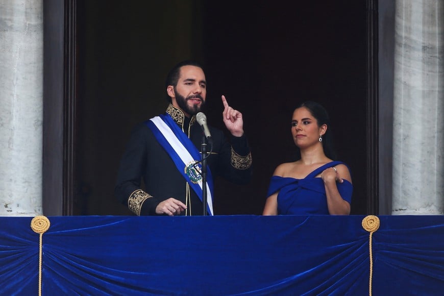 El Salvador's President Nayib Bukele speaks beside his wife, Gabriela de Bukele, at the balcony of the National Palace, after receiving the presidential sash, during his swearing-in ceremony for a second term, in San Salvador, El Salvador June 1, 2024. REUTERS/Jose Cabezas