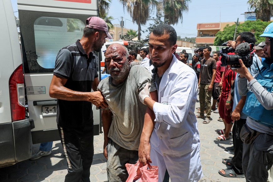 A Palestinian man is assisted in the aftermath of an Israeli strike, amid the Israel-Hamas conflict, at Al-Aqsa Martyrs Hospital in Deir Al-Balah, in the central Gaza Strip, June 8, 2024. REUTERS/Ramadan Abed