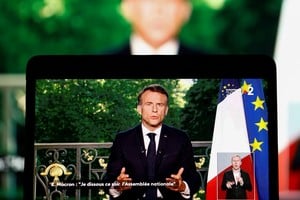 French President Emmanuel Macron appears on a screen as he delivers a speech following results after the polls closed in the European Parliament elections, in Paris, France, June 9, 2024. REUTERS/Christian Hartmann