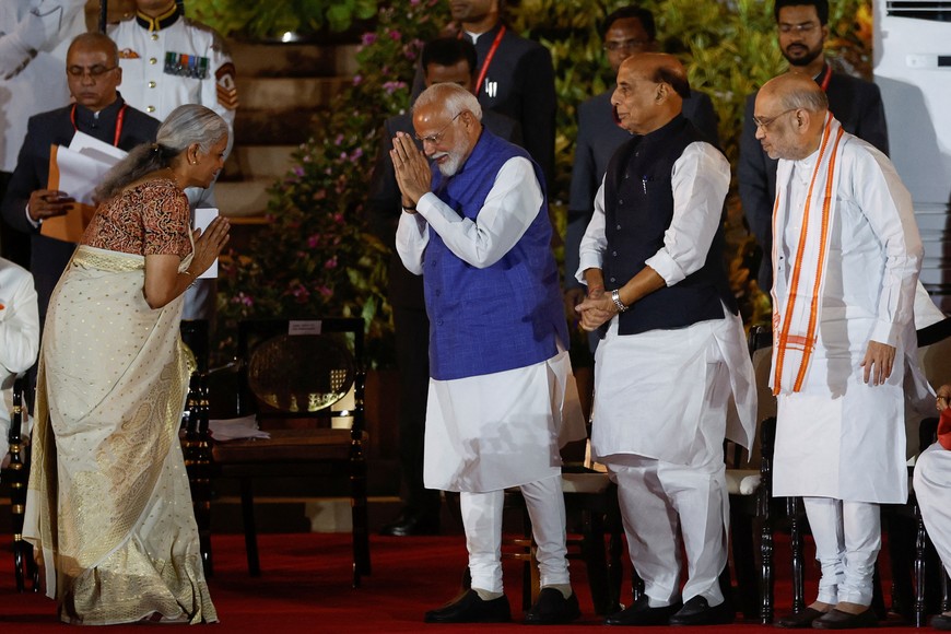Nirmala Sitharaman of the Bharatiya Janata Party (BJP) and India's Prime Minister Narendra Modi gesture at each other, during the swearing-in ceremony at the presidential palace in New Delhi, India, June 9, 2024. REUTERS/Adnan Abidi