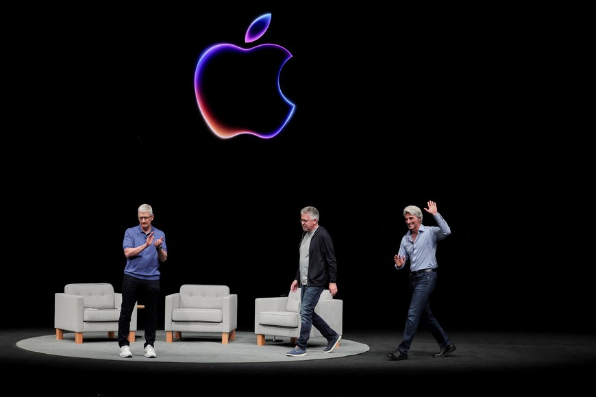 FILE PHOTO: Apple CEO Tim Cook attends a panel discussion with Craig Federighi and John Giannandrea during the annual developer conference event at the company's headquarters in Cupertino, California, U.S., June 10, 2024. REUTERS/Carlos Barria/File Photo