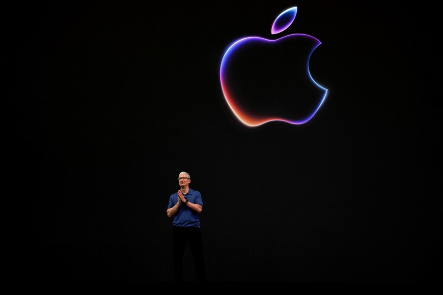 FILE PHOTO: Apple CEO Tim Cook attends the annual developer conference event at the company's headquarters in Cupertino, California, U.S., June 10, 2024. REUTERS/Carlos Barria/File Photo