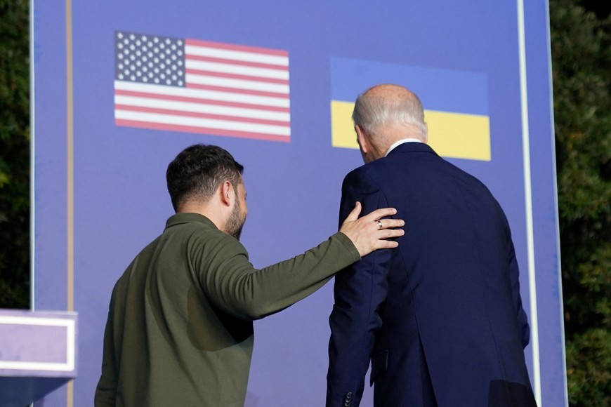 U.S. President Joe Biden and Ukrainian President Volodymyr Zelenskiy walk on the day of signing a new security agreement between the United States and Ukraine, in Fasano, Italy, June 13, 2024. REUTERS/Kevin Lamarque
