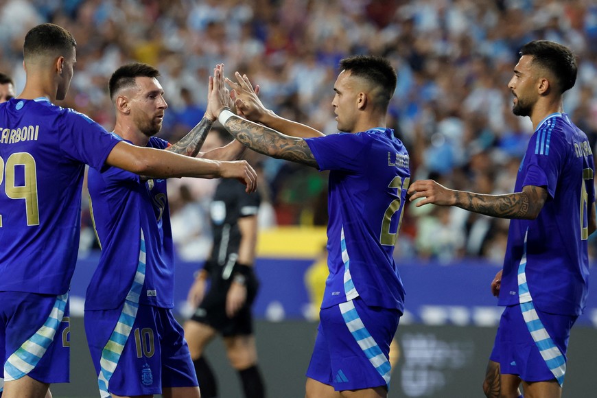 Jun 14, 2024; Landover, Maryland, USA; Argentina defender Laurtaro Martinez (22) celebrates with Argentina forward Lionel Messi (10) after scoring on a penalty against Guatemala in the first half at Commanders Field. Mandatory Credit: Geoff Burke-USA TODAY Sports