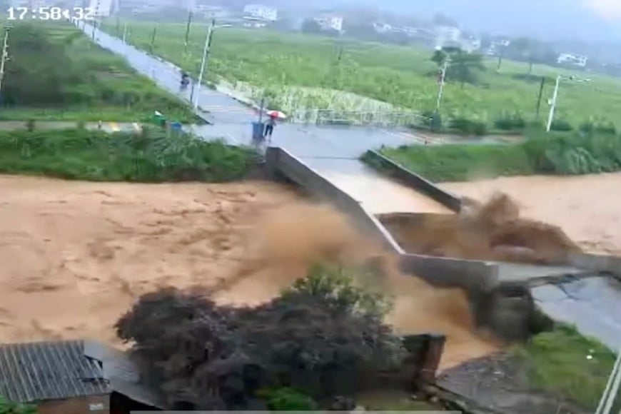 A bridge collapses following heavy rainfall and flooding in Dongshi Town, Meizhou City, Guangdong Province, China June 16, 2024, in this still image obtained from social media video.  VIDEO OBTAINED BY REUTERS/via REUTERS  THIS IMAGE HAS BEEN SUPPLIED BY A THIRD PARTY. NO RESALES. NO ARCHIVES.