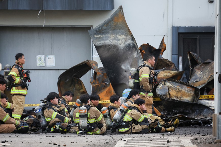 Firefighters take a break as rescue work continues following a deadly fire at a lithium battery factory owned by South Korean battery maker Aricell, in Hwaseong, South Korea, June 24, 2024. REUTERS/Kim Hong-ji