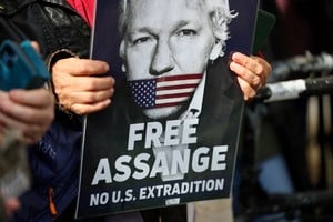 A supporter of WikiLeaks founder Julian Assange holds a sign, on the day the High Court is set to rule on whether Julian Assange can appeal against extradition from Britain to the United States, in London, Britain, March 26, 2024. REUTERS/Toby Melville