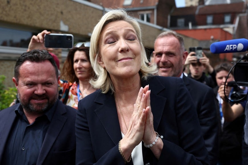 Marine Le Pen, French far-right leader and far-right Rassemblement National (National Rally - RN) party candidate, reacts while with Henin-Beaumont Mayor Steeve Briois and local RN politician Bruno Bilde, after she voted in the first round of the early French parliamentary elections, in Henin-Beaumont, France, June 30, 2024. REUTERS/Yves Herman     TPX IMAGES OF THE DAY