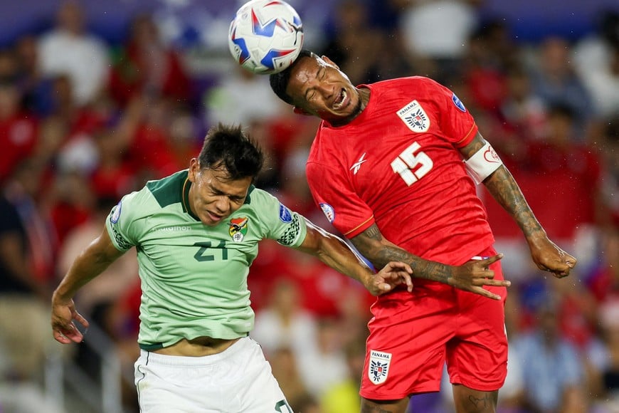 Jul 1, 2024; Orlando, FL, USA; Panama defender Eric Davis (15) heads the ball over Bolivia defender Jose Sagredo (21) in the second half during a Copa America group stage match at Inter&CO Stadium. Mandatory Credit: Nathan Ray Seebeck-USA TODAY Sports