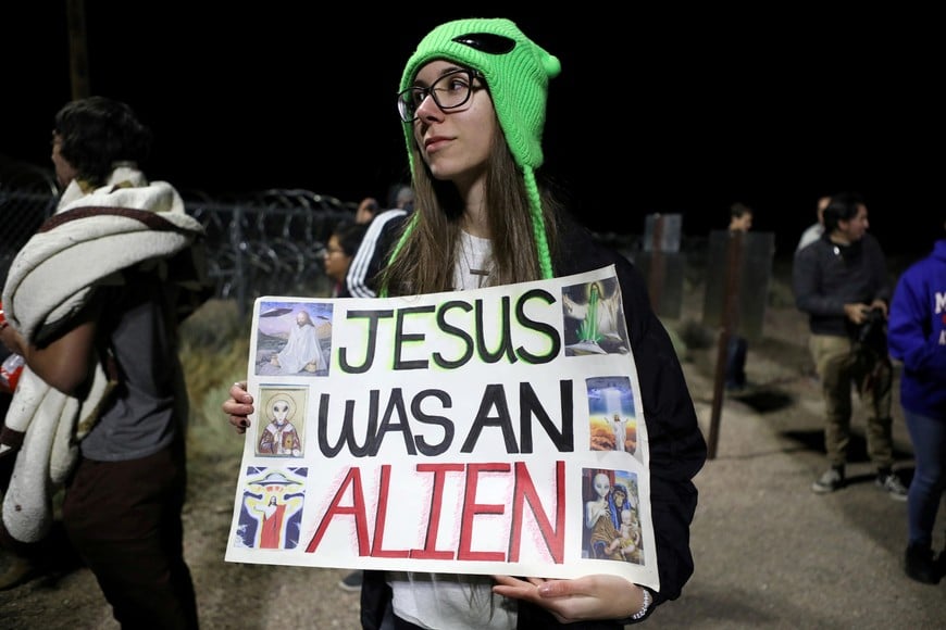 A person carries a sign outside a gate to Area 51 as an influx of tourists responding to a call to 'storm' Area 51, a secretive U.S. military base believed by UFO enthusiasts to hold government secrets about extra-terrestrials, is expected in Rachel, Nevada, U.S. September 20, 2019. REUTERS/Jim Urquhart