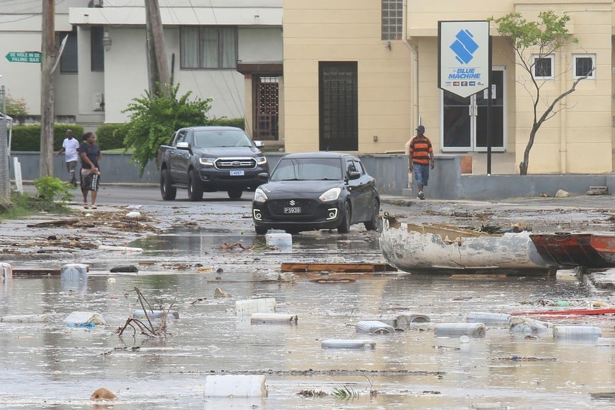 Cars enter a debris-filled street in the Hastings neighborhood after Hurricane Beryl passed in Bridgetown, Barbados July 1, 2024.  REUTERS/Nigel R Browne