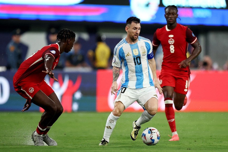 Soccer Football - Copa America 2024 - Semi Final - Argentina v Canada - MetLife Stadium, East Rutherford, New Jersey, United States - July 9, 2024
Argentina's Lionel Messi in action with Canada's Moise Bombito REUTERS/Agustin Marcarian