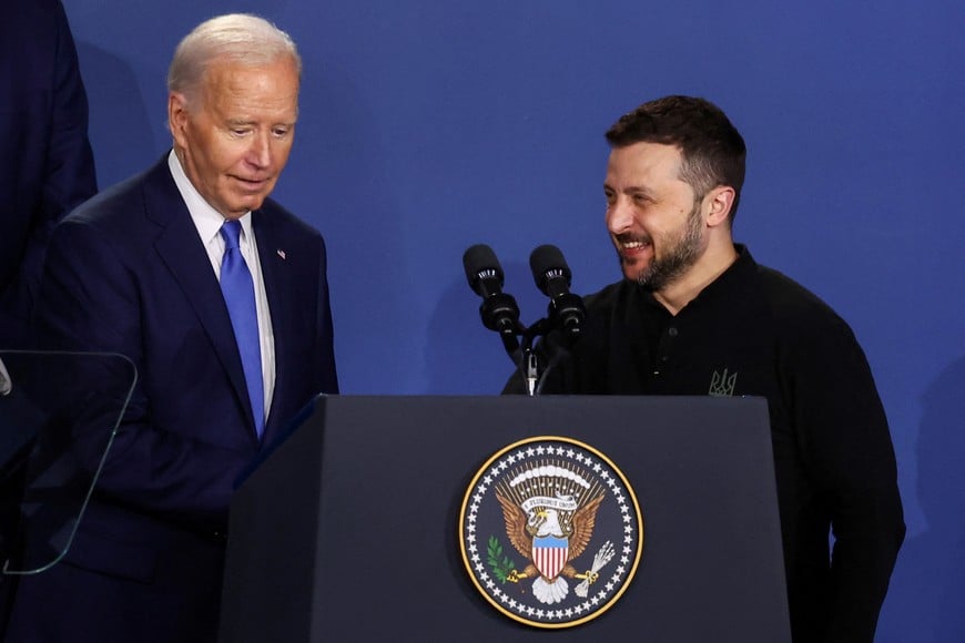 Ukraine's President Volodymyr Zelenskiy and U.S. President Joe Biden react as they attend a Ukraine Compact meeting, on the sidelines of the NATO's 75th anniversary summit in Washington, U.S. July 11, 2024. REUTERS/Yves Herman