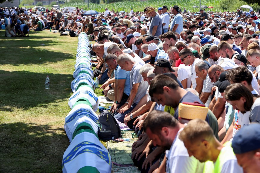 Bosnian Muslim men say prayer during a mass funeral at the Srebrenica Genocide Memorial in Potocari, Bosnia and Herzegovina, July 11, 2024. REUTERS/Amel Emric