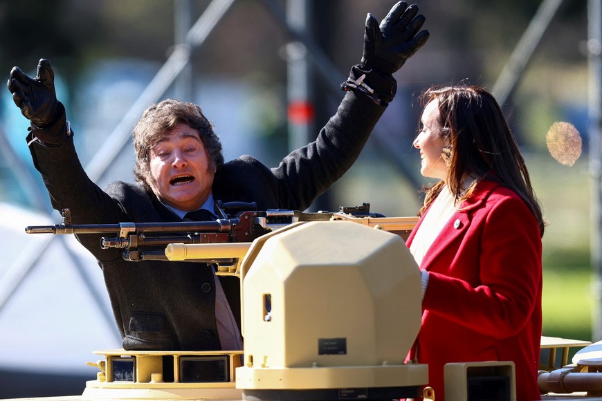 Argentina's President Javier Milei gestures from a military vehicle next to Vice President Victoria Villarruel, during a military parade commemorating the 208th anniversary of the country's independence from Spain in 1816, in Buenos Aires, Argentina July 9, 2024. REUTERS/Matias Baglietto