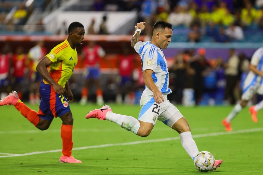 Jul 14, 2024; Miami, FL, USA; Argentina forward Lautaro Martinez (22) shoots and scores against Colombia against Colombia during the second half of extra time of the Copa America final at Hard Rock Stadium. Mandatory Credit: Sam Navarro-USA TODAY Sports