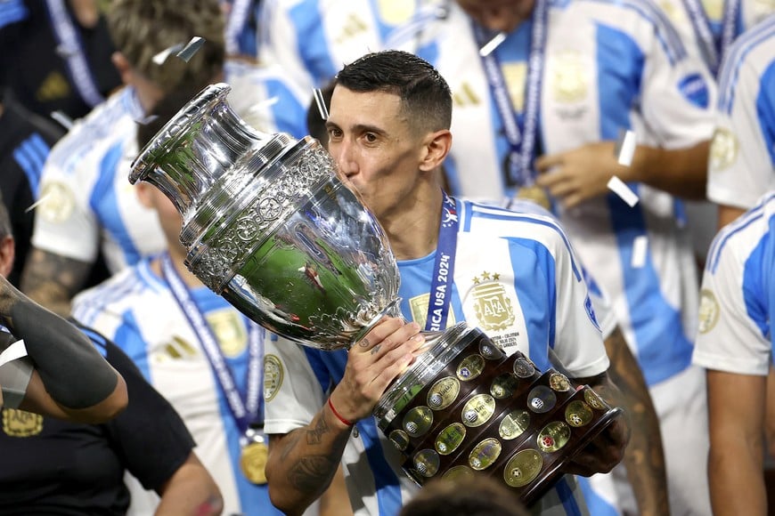 Soccer Football - Copa America 2024 - Final - Argentina v Colombia - Hard Rock Stadium, Miami, Florida, United States - July 15, 2024
Argentina's Angel Di Maria kisses the trophy as he celebrate after winning Copa America 2024 REUTERS/Agustin Marcarian