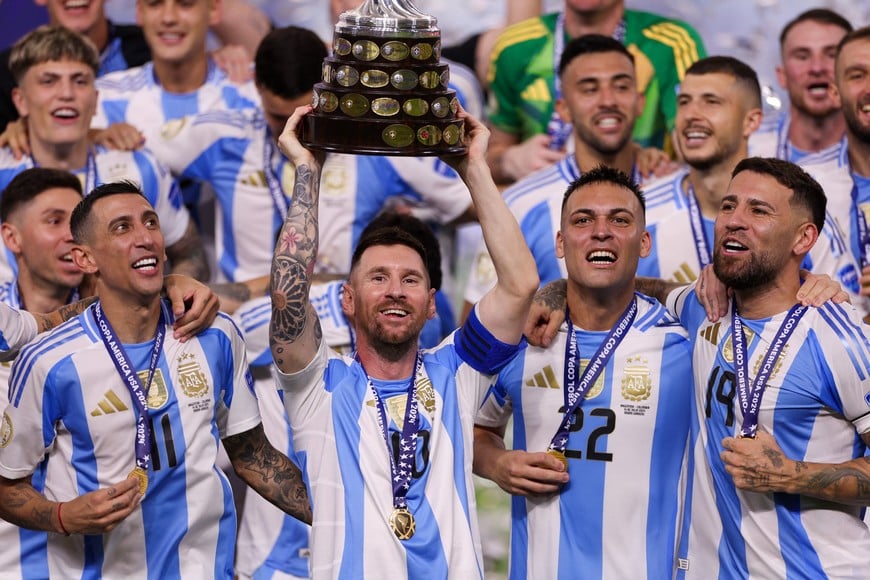 Jul 14, 2024; Miami, FL, USA;  Argentina forward Lionel Messi (10) midfielder Angel Di Maria (11) forward Lautaro Martínez (22) and defender Nicolas Otamendi (19) celebrate after winning the Copa America Final against Colombia at Hard Rock Stadium. Mandatory Credit: Nathan Ray Seebeck-USA TODAY Sports