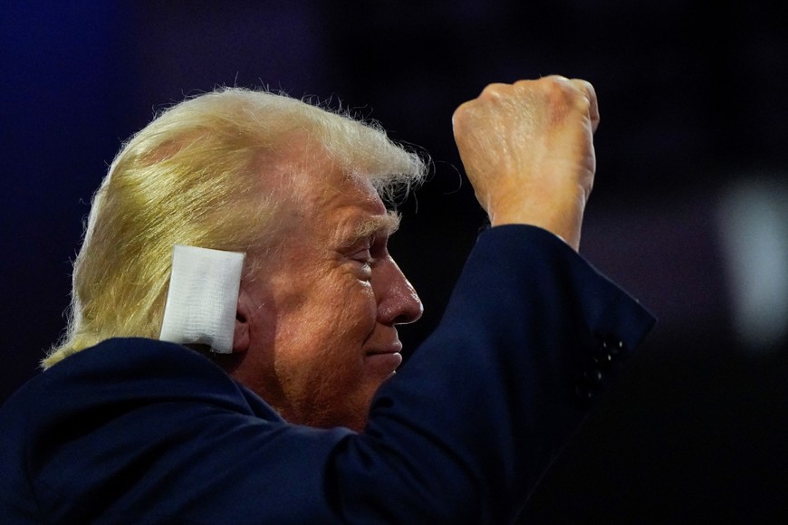 Republican presidential nominee and former U.S. President Donald Trump raises his fist during Day 1 of the Republican National Convention (RNC) at the Fiserv Forum in Milwaukee, Wisconsin, U.S., July 15, 2024. REUTERS/Elizabeth Frantz