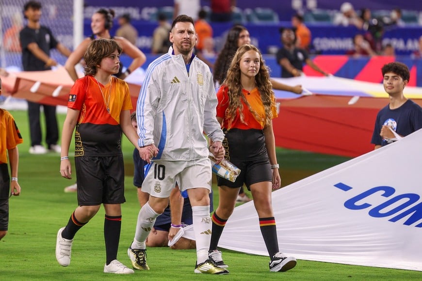Jul 14, 2024; Miami, FL, USA;  Argentina forward Lionel Messi (10) leads his teams procession before the Copa America Final against Colombia at Hard Rock Stadium. Mandatory Credit: Nathan Ray Seebeck-USA TODAY Sports