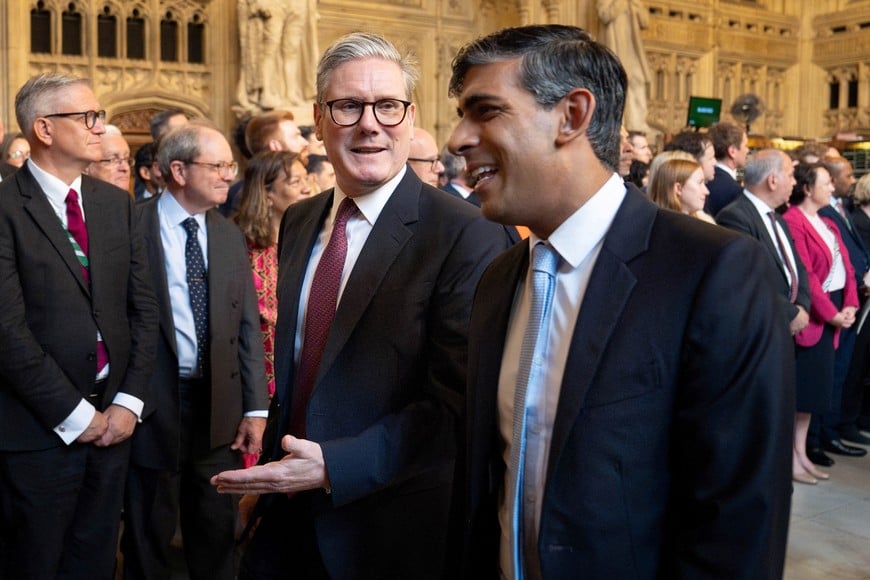 Prime Minister Keir Starmer and former Prime Minister Rishi Sunak walk through the Member's Lobby of the Houses of Parliament in London to the House of Lords to hear the King's Speech during the State Opening of Parliament, in London, Britain July 17, 2024. Stefan Rousseau/Pool via REUTERS