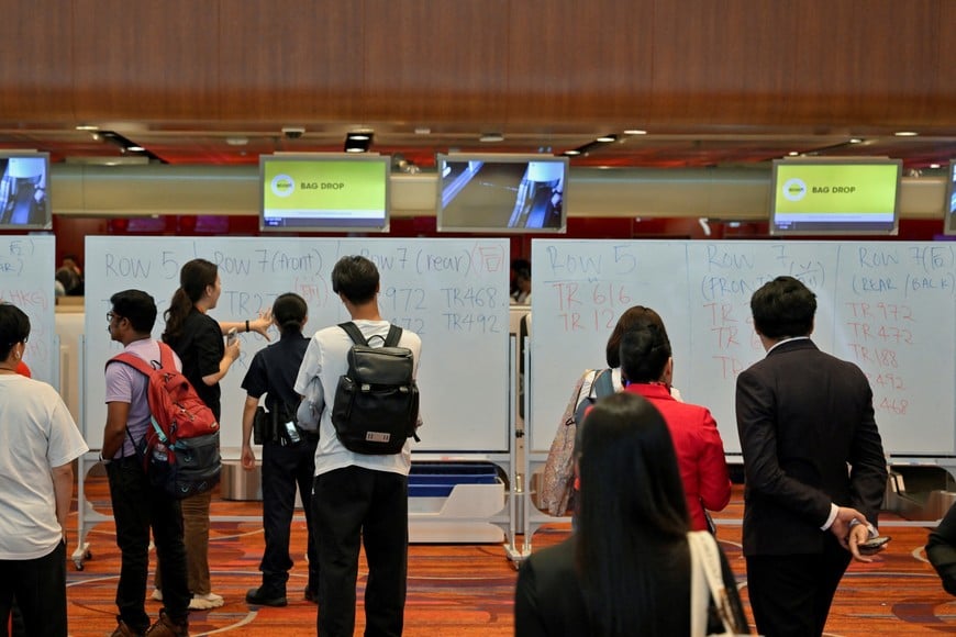 Airport staff use whiteboards to organise manual passenger check-in at Changi Airport Terminal 1 in Singapore after a global IT outage, July 19, 2024. REUTERS/Caroline Chia