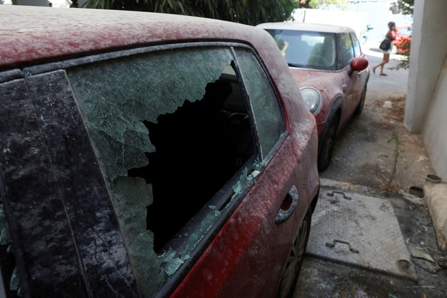 The damaged window of a car is pictured near the site of an explosion, amid the Israel-Hamas conflict in Tel Aviv, Israel July 19, 2024. REUTERS/Ricardo Moraes