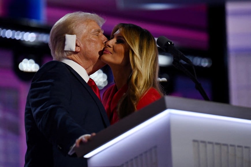 Republican presidential nominee and former U.S. President Donald Trump is joined on stage by his wife Melania after he finished giving his acceptance speech on Day 4 of the Republican National Convention (RNC), at the Fiserv Forum in Milwaukee, Wisconsin, U.S., July 18, 2024. REUTERS/Callaghan O'hare     TPX IMAGES OF THE DAY