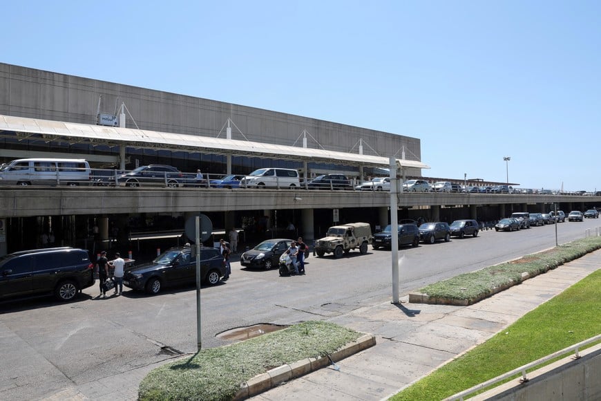 Cars are parked as people walk outside Beirut–Rafic Hariri International Airport, in Beirut, Lebanon July 29, 2024. REUTERS/Emilie Madi