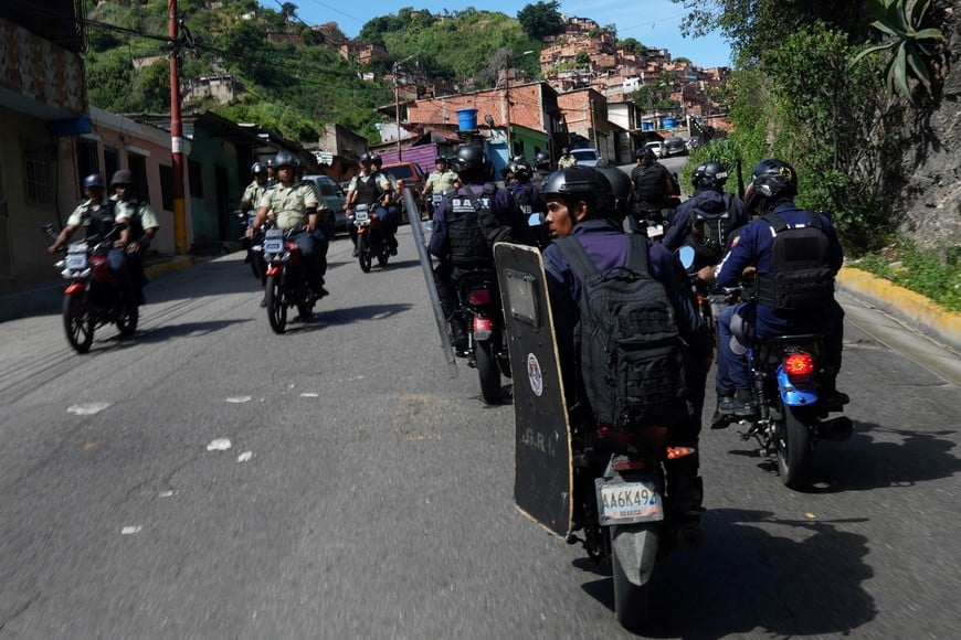 Venezuelan police patrols a neighborhood a day after supporters of Venezuelan opposition protested following the announcement by the National Electoral Council that Venezuela's President Nicolas Maduro won the presidential election, in Caracas, Venezuela July 30, 2024. REUTERS/Alexandre Meneghini