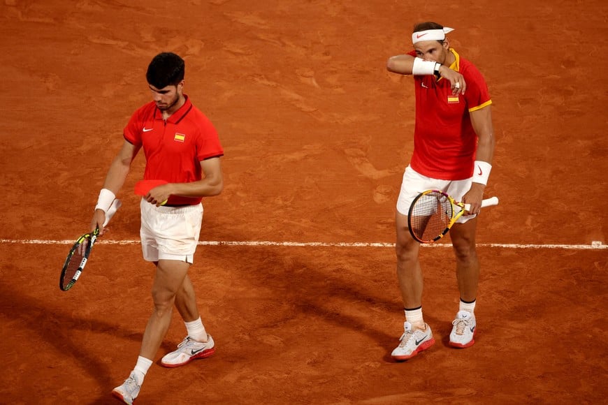 Paris 2024 Olympics - Tennis - Men's Doubles Quarterfinals - Roland-Garros Stadium, Paris, France - July 31, 2024.
Carlos Alcaraz of Spain and Rafael Nadal of Spain react during their match against Austin Krajicek of United States and Rajeev Ram of United States. REUTERS/Phil Noble     TPX IMAGES OF THE DAY