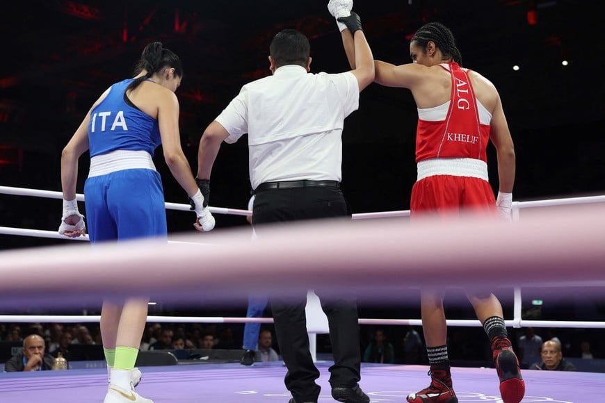 Paris 2024 Olympics - Boxing - Women's 66kg - Prelims - Round of 16 - North Paris Arena, Villepinte, France - August 01, 2024.
Imane Khelif of Algeria has her hand raised after her fight against Angela Carini of Italy. REUTERS/Isabel Infantes