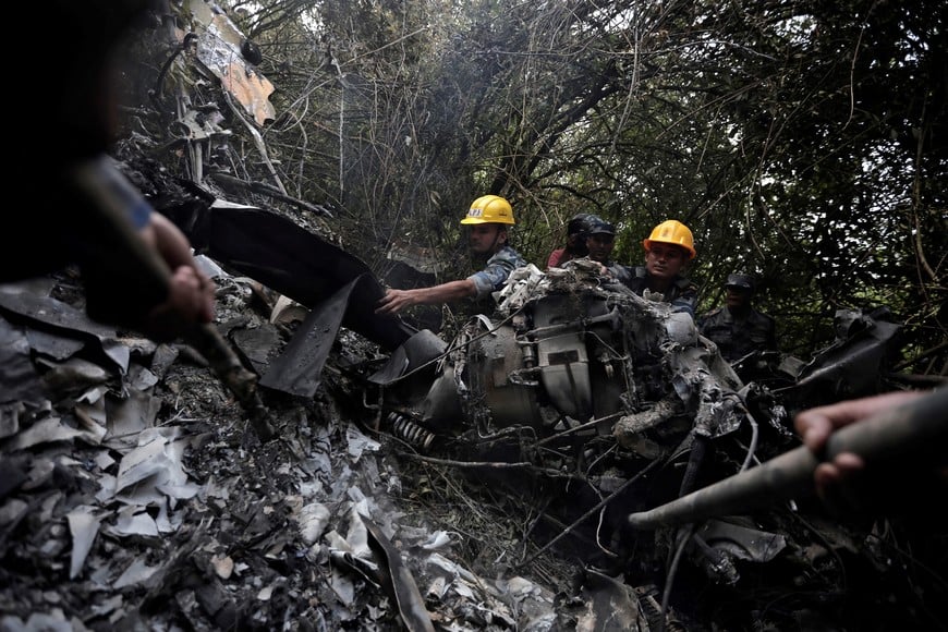 Security force personnel search for the victims at the site of a helicopter crash on the outskirts of Kathmandu, Nepal, August 7, 2024. REUTERS/Navesh Chitrakar