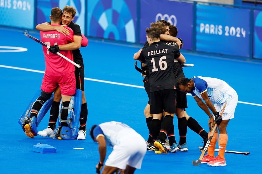 Paris 2024 Olympics - Hockey - Men's Semi-final - Germany vs India - Yves-du-Manoir Stadium, Colombes, France - August 06, 2024.
Jean-Paul Danneberg of Germany, Moritz Ludwig of Germany, Gonzalo Peillat of Germany and Mathias Mueller of Germany celebrate with teammates winning the match. REUTERS/Anushree Fadnavis