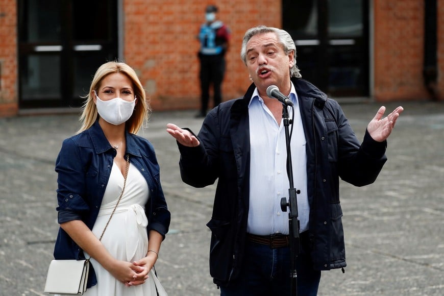 Argentina's President Alberto Fernandez and first lady Fabiola Yanez speak to the media outside a polling station after casting their vote in a midterm legislative election, in Buenos Aires, Argentina, November 14, 2021. REUTERS/Agustin Marcarian