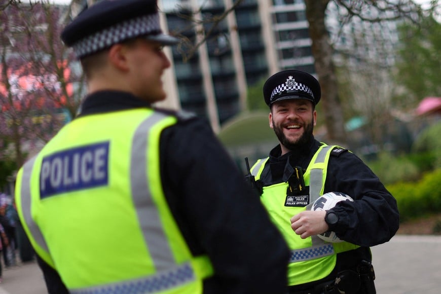 Soccer Football -  FA Cup - Semi Final - Manchester City v Sheffield United - Wembley Stadium, London, Britain - April 22, 2023
A police officer outside the stadium holds a football REUTERS/Carl Recine