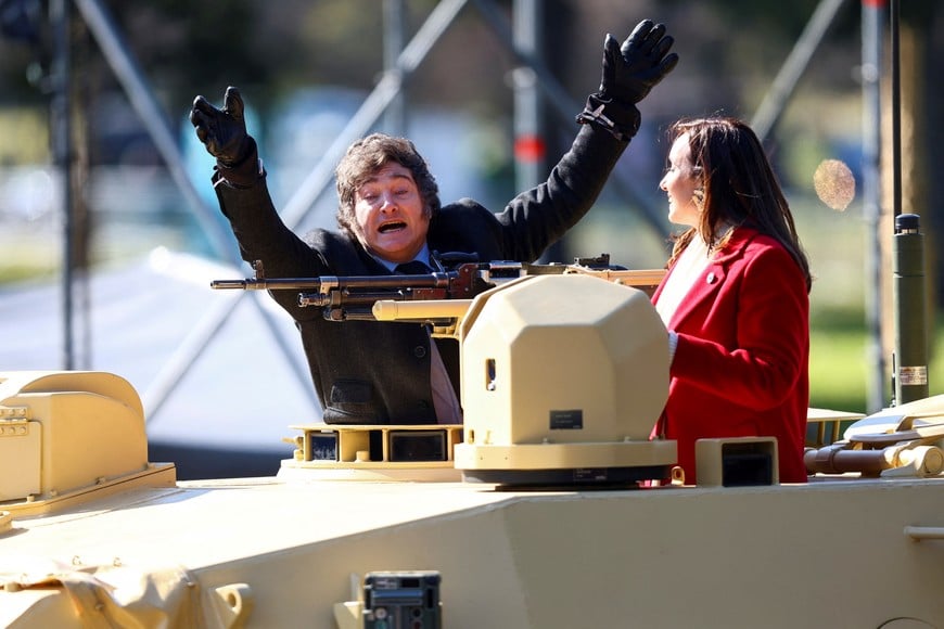 Argentina's President Javier Milei gestures from a military vehicle next to Vice President Victoria Villarruel, during a military parade commemorating the 208th anniversary of the country's independence from Spain in 1816, in Buenos Aires, Argentina July 9, 2024. REUTERS/Matias Baglietto