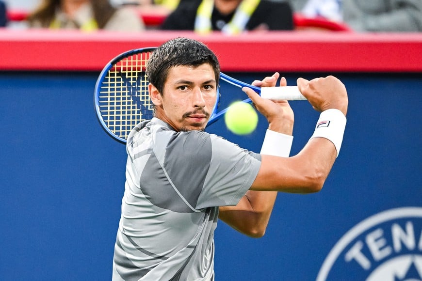 Aug 12, 2024; Montreal, Quebec, Canada; Alexei Popyrin (AUS) returns the ball to Andrey Rublev (not pictured) during singles final play at IGA Stadium. Mandatory Credit: David Kirouac-USA TODAY Sports