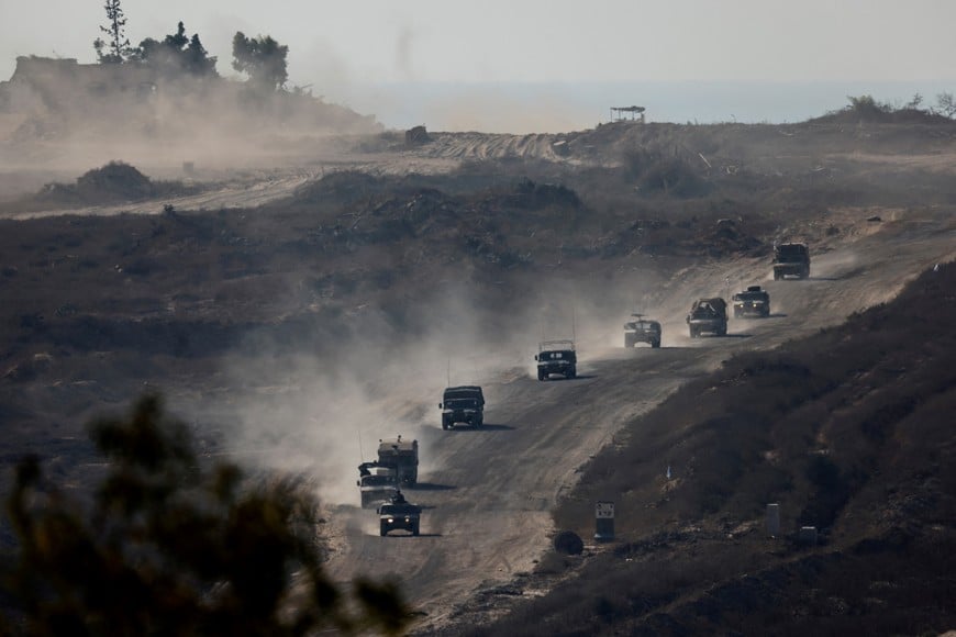 An Israeli military convoy moves inside the Gaza Strip, amid the ongoing conflict between Israel and Hamas, as seen from Israel, August 14, 2024. REUTERS/Amir Cohen     TPX IMAGES OF THE DAY