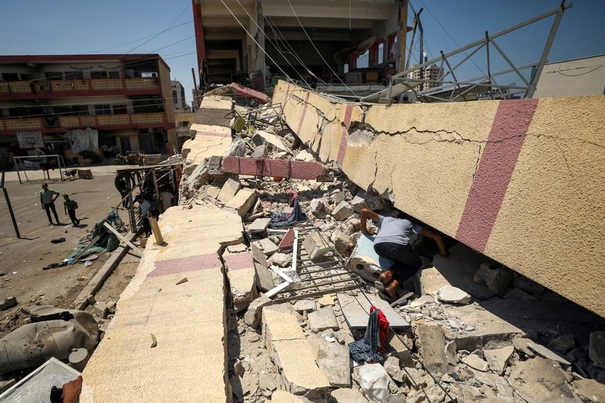 Palestinians inspect a school sheltering displaced people after it was hit by an Israeli strike, amid the Israel-Hamas conflict, in Gaza City, August 20, 2024. REUTERS/Dawoud Abu Alkas