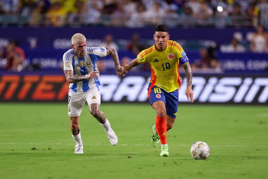 Jul 14, 2024; Miami, FL, USA; Colombia midfileder James Rodriguez (10) controls the ball from Argentina midfielder Rodrigo De Paul (7) in the first half during the Copa America Final at Hard Rock Stadium. Mandatory Credit: Nathan Ray Seebeck-USA TODAY Sports