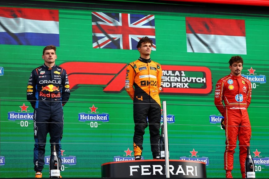 Formula One F1 - Dutch Grand Prix - Circuit Zandvoort, Zandvoort, Netherlands - August 25, 2024
McLaren's Lando Norris celebrates on the podium after winning the Dutch Grand Prix alongside second placed Red Bull's Max Verstappen and third placed Ferrari's Charles Leclerc REUTERS/Lisi Niesner