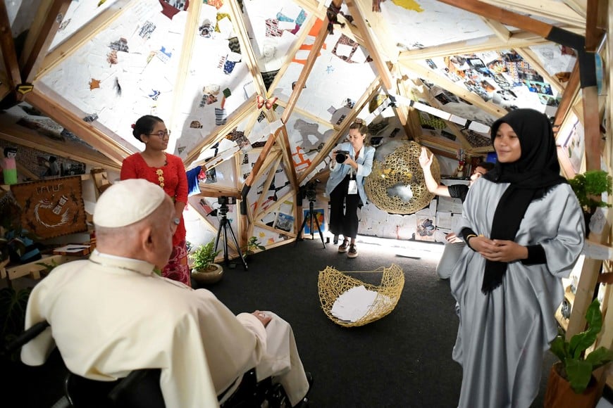 Pope Francis sits inside an installation, created in the shape of polyhedron, as he meets with Scholas Occurrentes youths at the Youth Center of Graha Pemuda, in Jakarta, Indonesia September 4, 2024.  Vatican Media/­Handout via REUTERS    ATTENTION EDITORS - THIS IMAGE WAS PROVIDED BY A THIRD PARTY.