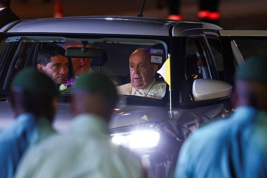 Pope Francis sits in a car after landing at Port Moresby Jackson International Airport, in Port Moresby, Papua New Guinea, September 6, 2024. REUTERS/Guglielmo Mangiapane