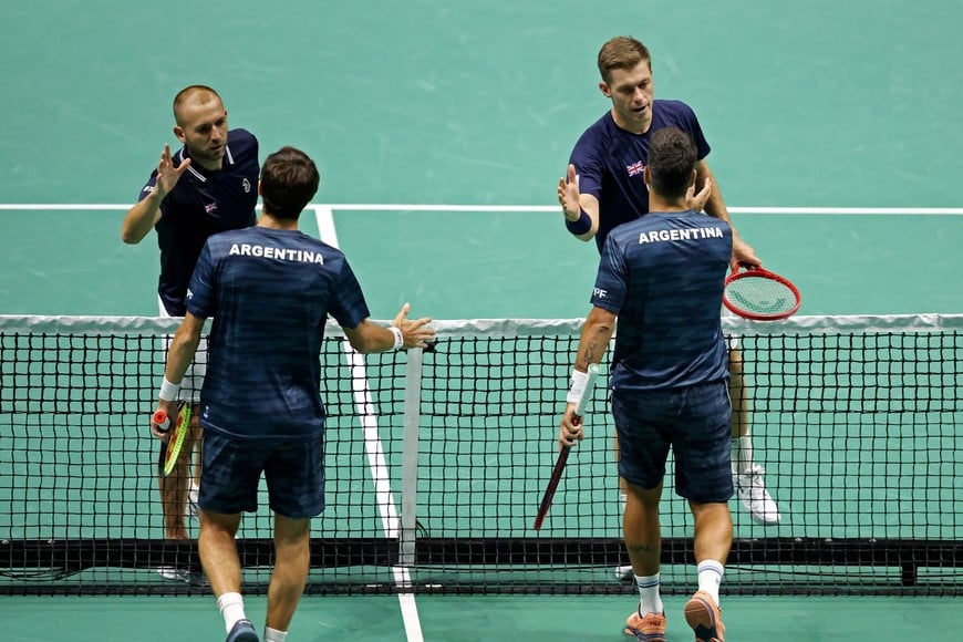 Tennis - Davis Cup - Group D - Britain v Argentina - AO Arena, Manchester, Britain - September 13, 2024  
Britain's Daniel Evans and Neal Skupski shake hands with Argentina's Maximo Gonzalez and Andres Molteni at the net after Evans and Skupski won the doubles match Action Images via Reuters/Craig Brough