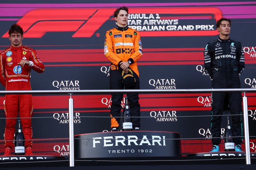 Formula One F1 - Azerbaijan Grand Prix - Baku City Circuit, Baku, Azerbaijan - September 15, 2024
McLaren's Oscar Piastri celebrates on the podium after winning the Azerbaijan Grand Prix with second placed Ferrari's Charles Leclerc and third placed Mercedes' George Russell REUTERS/Hannah Mckay