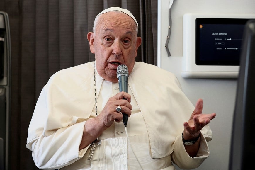 FILE PHOTO: Pope Francis holds a news conference aboard the papal plane on his flight back after his 12-day journey across Southeast Asia and Oceania, September 13, 2024. REUTERS/Guglielmo Mangiapane/Pool/File Photo