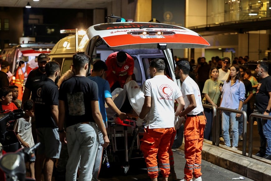 A person is carried on a stretcher outside American University of Beirut Medical Center (AUBMC) as people, including Hezbollah fighters and medics, were wounded and killed when the pagers they use to communicate exploded across Lebanon, according to a security source, in Beirut, Lebanon September 17, 2024. REUTERS/Mohamed Azakir