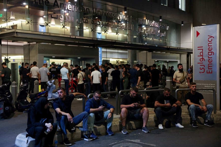 People gather outside American University of Beirut Medical Center (AUBMC) in Beirut, after hand-held radios used by Hezbollah detonated on Wednesday across Lebanon's south and in Beirut's southern suburbs, a security source and a witness said, Lebanon September 18, 2024. REUTERS/Mohamed Azakir